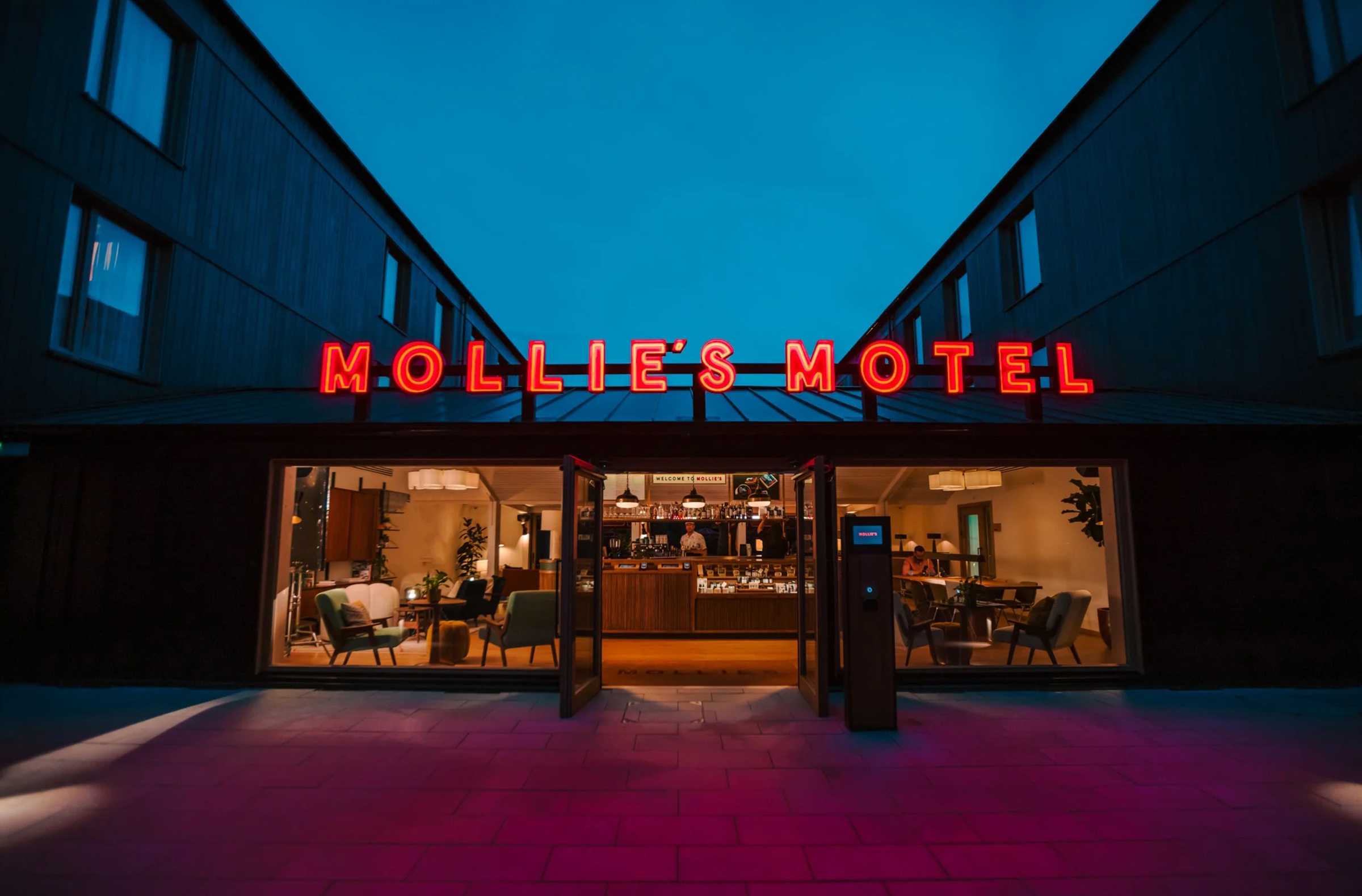 Mollie's Motel entrance with red neon branding